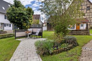 a patio with a table and chairs in a yard at Ruhig Wohnen in Sulz in Sulz am Neckar