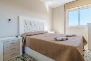 a bedroom with a bed with two pillows on it at Apartamento Carmen in Fuengirola