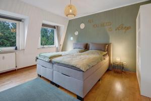 a bedroom with a large bed in a room with a wall at Ferienwohnung Berti in Heeßen