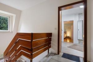 a hallway with a wooden door and a mirror at Ferienwohnung Berti in Heeßen +20 photos