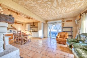 a living room with a couch and chairs and a table at L'Ecurie in Guizengeard