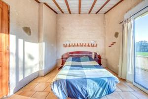a bedroom with a bed in a room with a window at L'Ecurie in Guizengeard