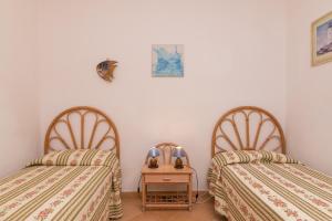 two beds sitting next to each other in a room at Casa Mabelle in Palau