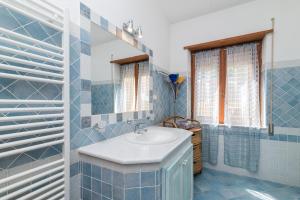 a bathroom with a sink and a mirror at Casa Mabelle in Palau +16 photos