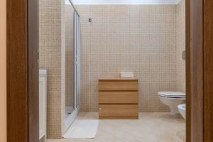 a bathroom with a toilet and a sink and a shower at Rosa dei Venti Grottaglie in Grottaglie +12 photos