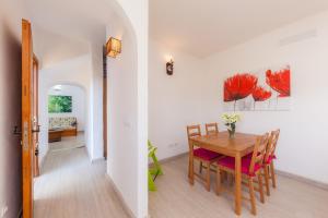a kitchen and dining room with a table and chairs at Sa Casona in Portocolom +27 photos
