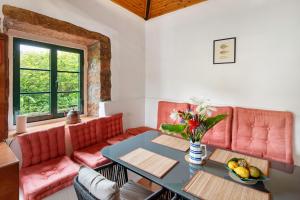 a living room with red couches and a table at Quinta das Queimadas in Nordeste