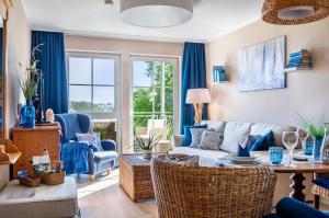 a living room with a couch and chairs and a table at Seeblicksuiten - Suite Seelixir in Enderndorf