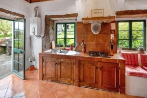 a kitchen with a sink and a couch in a room at Quinta das Queimadas in Nordeste +68 photos