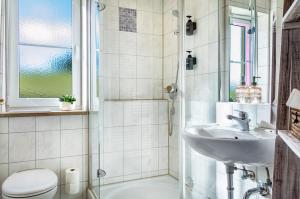 a bathroom with a sink and a toilet at Seeblicksuiten - Suite Seelixir in Enderndorf +28 photos