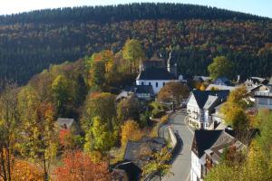 an autumn view of a small town in the mountains at Ferienwohnung Voege am Waldrand in Schmallenberg