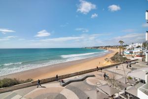 a view of a beach and the ocean at Apartamento Caravela in Armação de Pêra