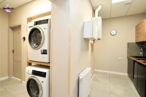 a laundry room with a washer and dryer at MMRent Grape Room in Gdańsk