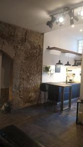 a kitchen with a table in the middle of a room at Appartamento Luxury - Torre in Terracina
