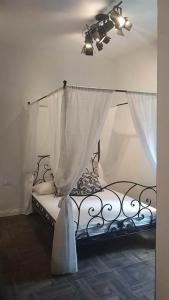 a bedroom with a bed with a curtain at Appartamento Luxury - Torre in Terracina