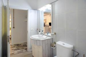 a white bathroom with a sink and a toilet at Las Sales Estudio in Moya +10 photos