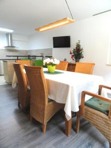 a dining room with a white table and chairs at Karins Pension in Lampertheim +48 photos