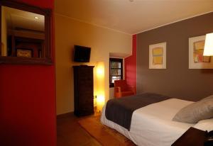 a hotel room with a bed and a mirror at luxury stone villa in Girona