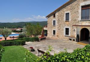 an external view of a building with a swimming pool at luxury stone villa in Girona
