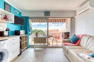 a living room with a couch and a table at Les Ptits Loups, le Grau d'Agde in Le Grau-dʼAgde