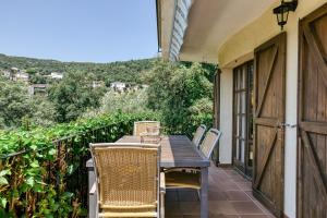 a table and chairs on the balcony of a house at Castell Mirto - villa private pool in Calonge