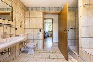 a bathroom with a toilet and a sink at B463 Penthouse in Albstadt +26 photos