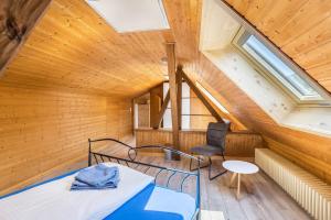 an attic room with a bed and a chair at B463 Penthouse in Albstadt