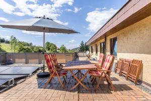 a patio with a table and chairs and an umbrella at B463 Penthouse in Albstadt