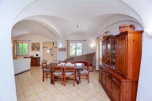 a kitchen and dining room with a table and chairs at Villa Funtana Cortese in Orosei