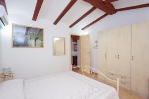 a bedroom with a white bed in a room at Villa Funtana Cortese in Orosei +37 photos
