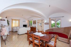 a living room with a table and a couch at Villa Funtana Cortese in Orosei