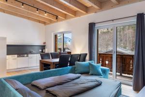 a living room with a blue couch and a table at Apartment Lorenz in Scharnitz