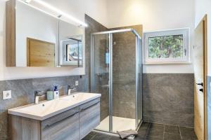 a bathroom with a sink and a shower at Apartment Lorenz in Scharnitz +18 photos