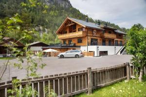 a white car parked in front of a building at Apartment Lorenz in Scharnitz