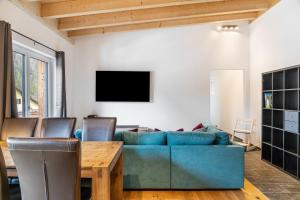 a living room with a blue couch and a table at Apartment Lorenz in Scharnitz