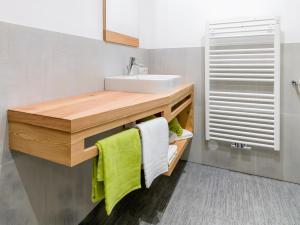 a bathroom with a sink and a mirror at Altmessnerhof in Dobbiaco +39 photos