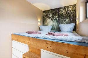 a bedroom with two dolls on a wooden bed at Nova Ferienhaus, 50qm in Ueckermünde