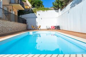 a swimming pool with blue water in a house at Dorada Apartment Lluna in Calafell +12 photos