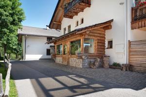 a log home with a porch and a building at Paracia App Pic Pec in Badia