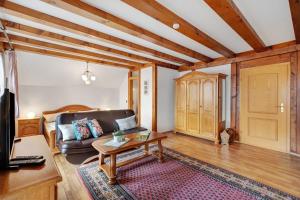 a living room with a couch and a table at Gästehaus Weingut Mangel in Endingen