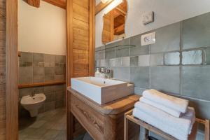 a bathroom with a sink and a toilet at Civico 9 in Marmora +8 photos