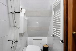 a small white bathroom with a toilet and stairs at Ca Du Grifun - Vernazza in Vernazza +14 photos