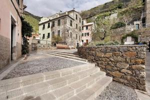 a group of stone stairs next to a stone wall at Ca Du Grifun - Vernazza in Vernazza