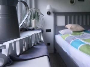 a small bedroom with a bed and a lamp at Fewo Meisennest, 50 Qm in Saalhausen