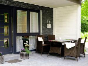 a patio with a table and chairs on it at Fewo Meisennest, 50 Qm in Saalhausen