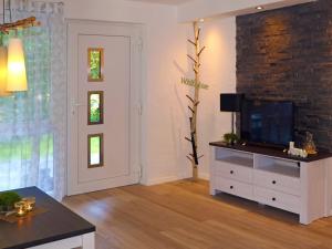 a living room with a tv on a dresser at Fewo Meisennest, 50 Qm in Saalhausen