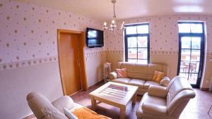 a living room with two couches and a tv at Ferienbauernhof - Ferienwohnung 6 in Grünow