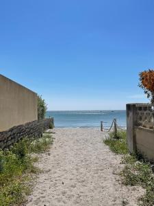 an empty beach with the ocean in the background at La Paillote in Loctudy