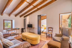 a living room with a couch and a chair at Son Sunyer in La Aranjasa