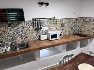 a kitchen with a counter with a microwave on it at Villa Almagre in Gáldar